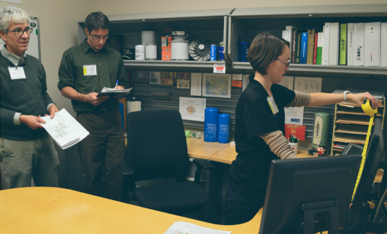 women measuring a desk space